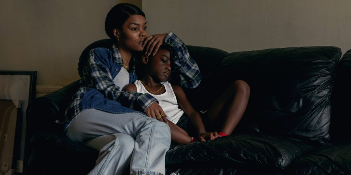 A woman and a little girl are seated on the couch